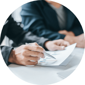 A close up with a paper being reviewed by two people
