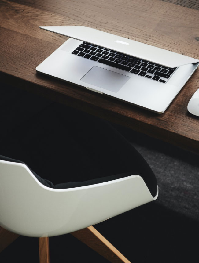 Chair in front of a desk with a laptop