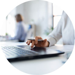 Person working on a laptop in an office environment