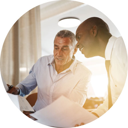 Two people reviewing papers together in an office environment